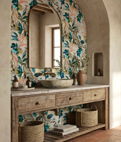 Bathroom vanity with Cheetah wallpaper, round mirror, and decorative elements.