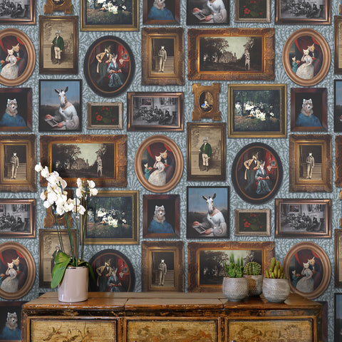 Teal animal portrait gallery wallpaper above antique console with orchids and cactus plants
