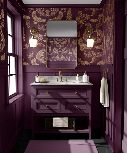 Burgundy and gold woodland wallpaper used as a dramatic feature wall in a warm, elegant bathroom interior
