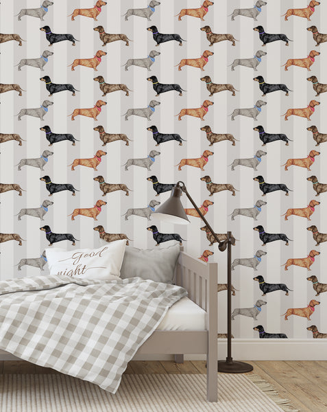 Dachshund dog wallpaper in a child’s bedroom with neutral bed, checked bedding and reading lamp