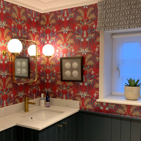 Red leopard wallpaper pattern with leaping leopards, golden palm leaves, pineapples and tropical foliage