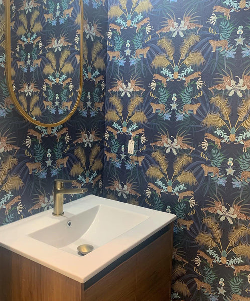 Blue Leopard Luxe wallpaper used as a luxury statement wall with gold palm details and animal print design