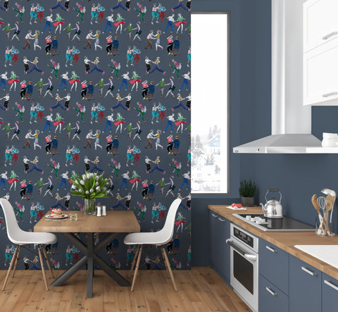 Blue dance wallpaper used as a kitchen feature wall above marble worktops and dark blue cabinets