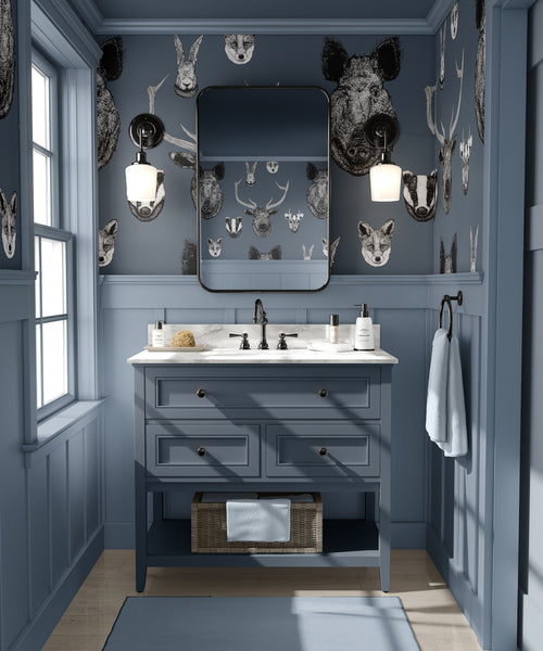 Blue British wildlife wallpaper used in a study or bedroom with heritage animal illustrations and classic interior styling