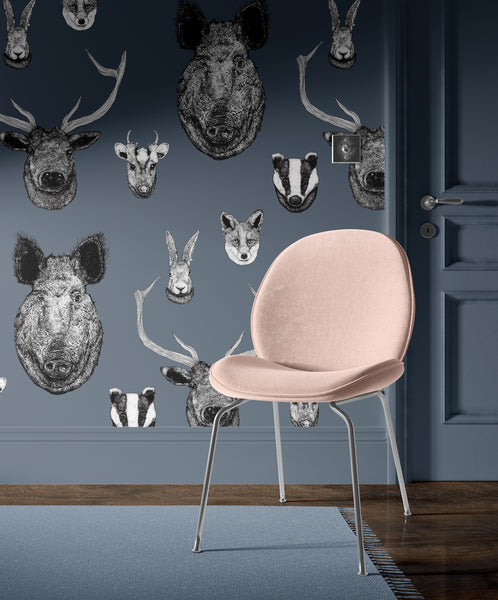 Blue British wildlife wallpaper used in a study or bedroom with heritage animal illustrations and classic interior styling