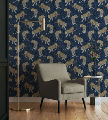 Blue leopard print wallpaper pattern with hand-painted prowling leopards on a rich tonal animal skin background