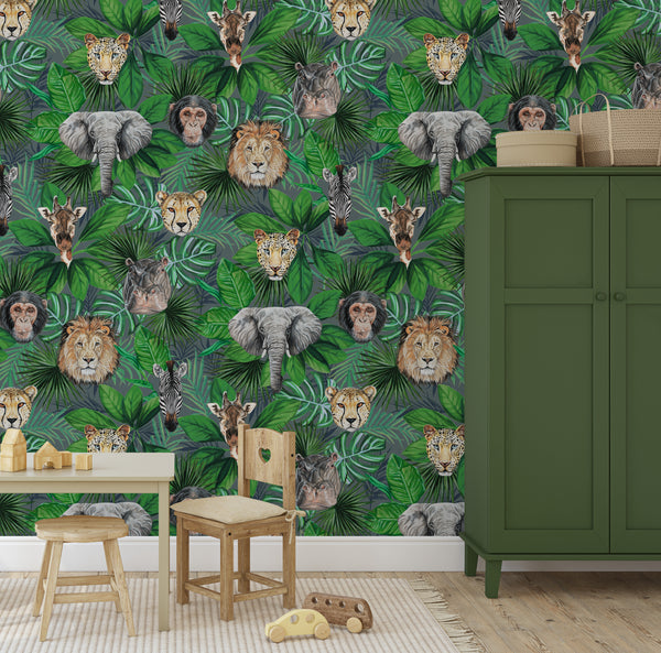 Green safari animal wallpaper in a children’s playroom with green wardrobe, wooden table and toy animals